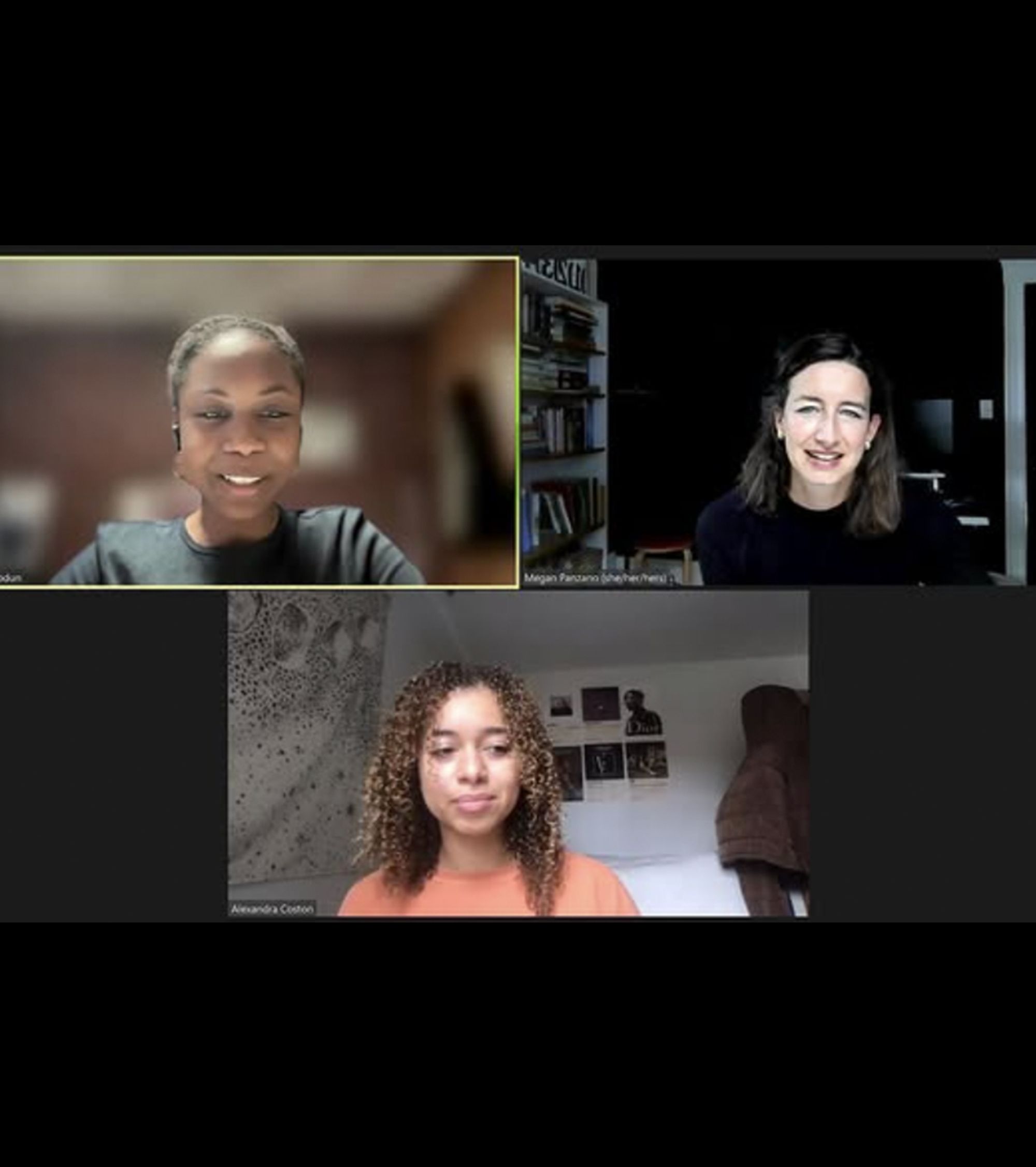 Screenshot of a three-person Zoom meeting. The top-left participant, identified as Wonu M Abiodun, is smiling and wearing a black top with an earpiece. The top-right participant, Megan Parzonko (she/her/hers), has shoulder-length dark hair and is smiling in front of a bookshelf and dark background. The bottom participant, Alexandra Coston, is sitting in a well-lit bedroom with curly hair and an orange sweater; there are posters and a tapestry on the wall behind her.
